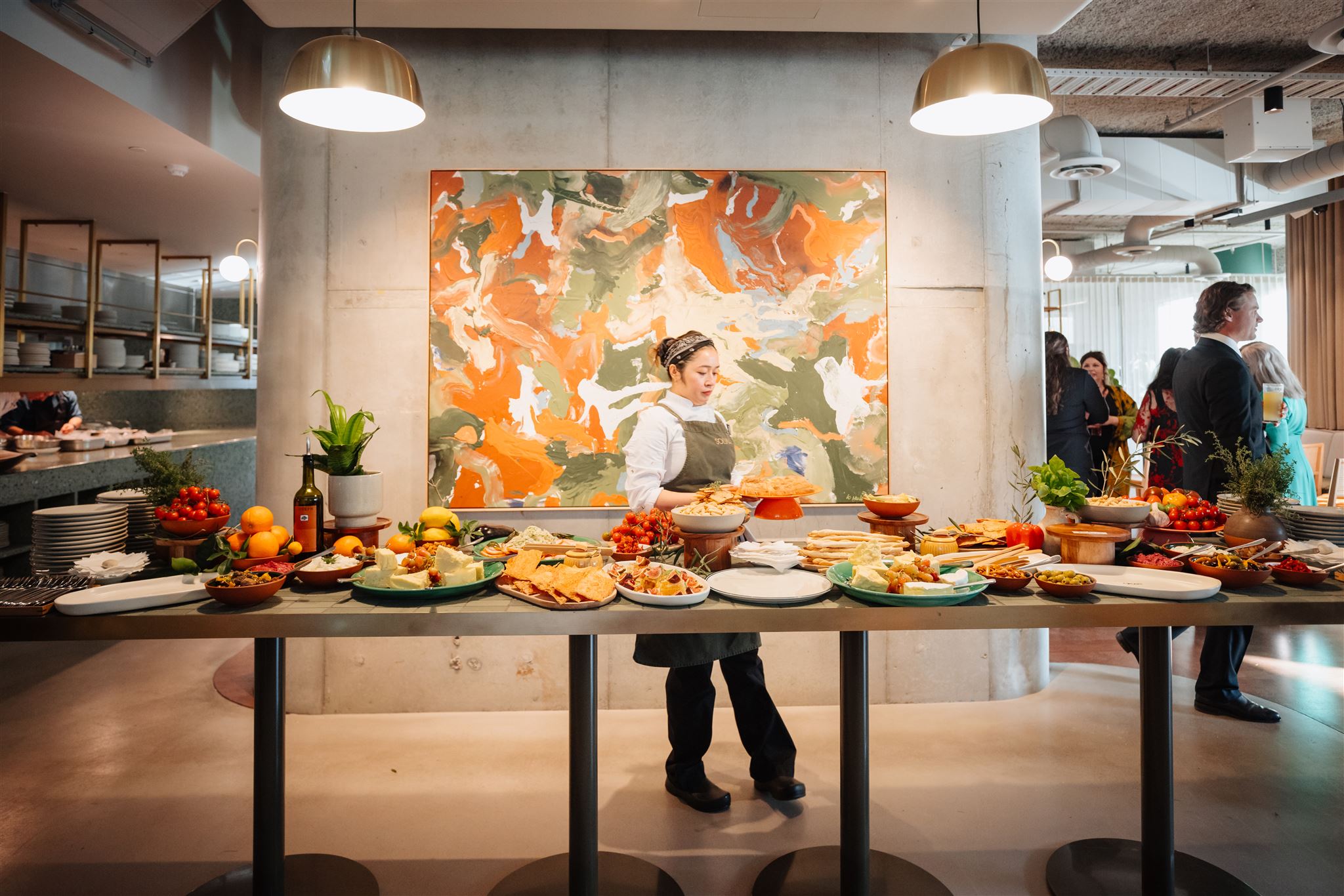 chef infront of buffet station full of food for event