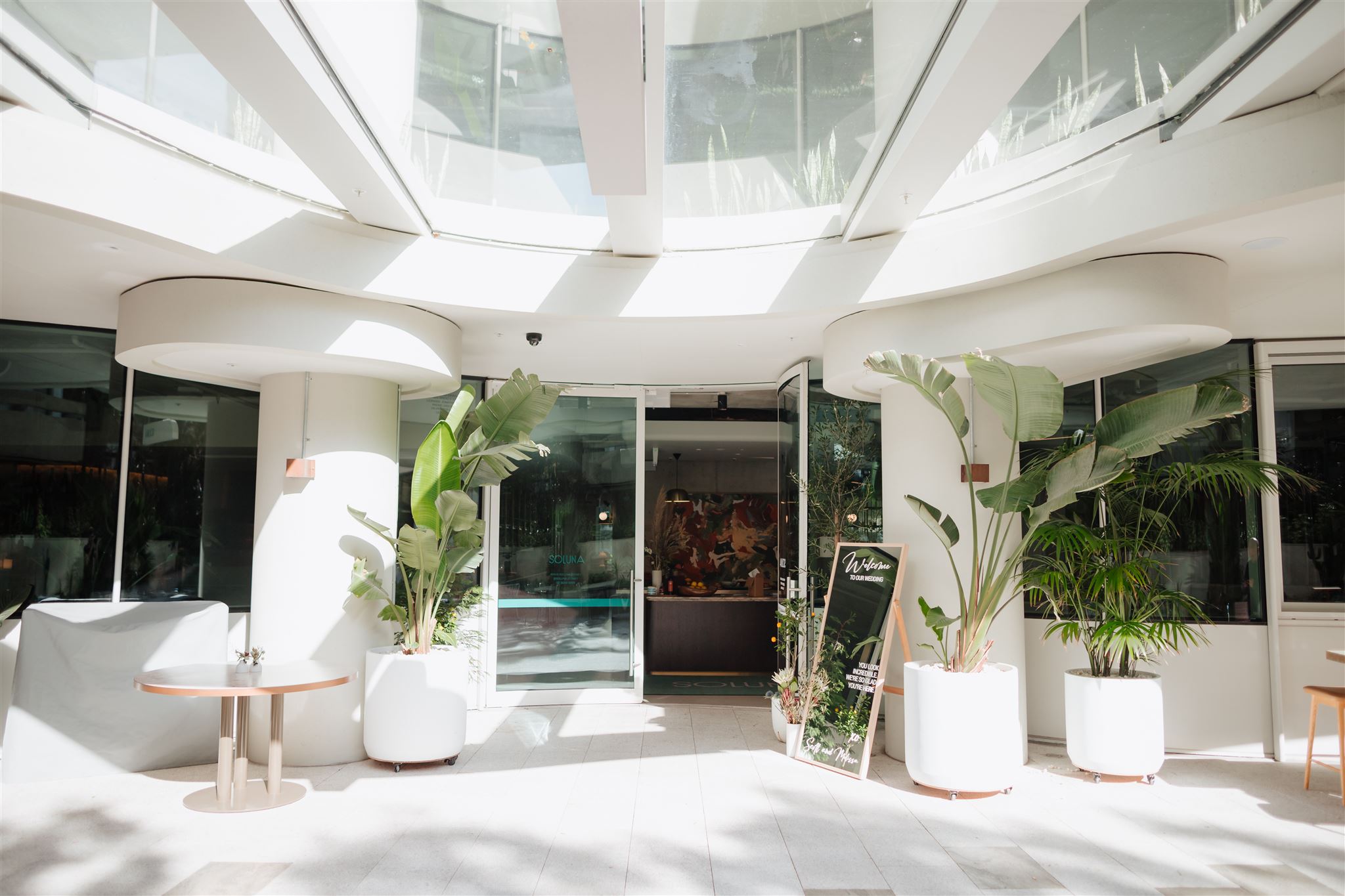 exterior doors to restaurant with green palms